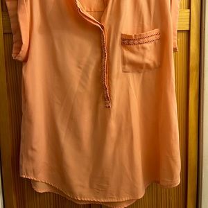 Orange/Peach colored women’s top with cap sleeves